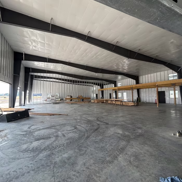 Interior view of the building's steel framing and wood mezzanine
